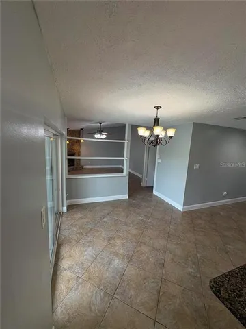 a view of a hallway with a kitchen
