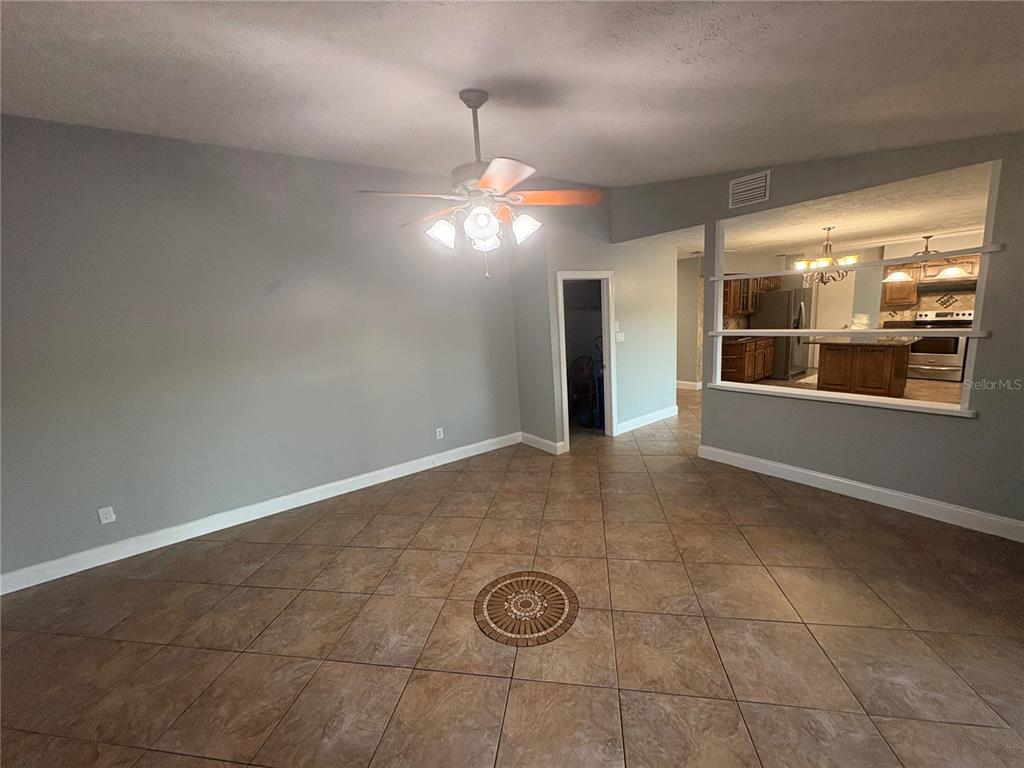 3904 Sweetleaf Drive Brandon, FL 33511 - Photo 19 of 34 a view of an empty room with a fireplace and a fan