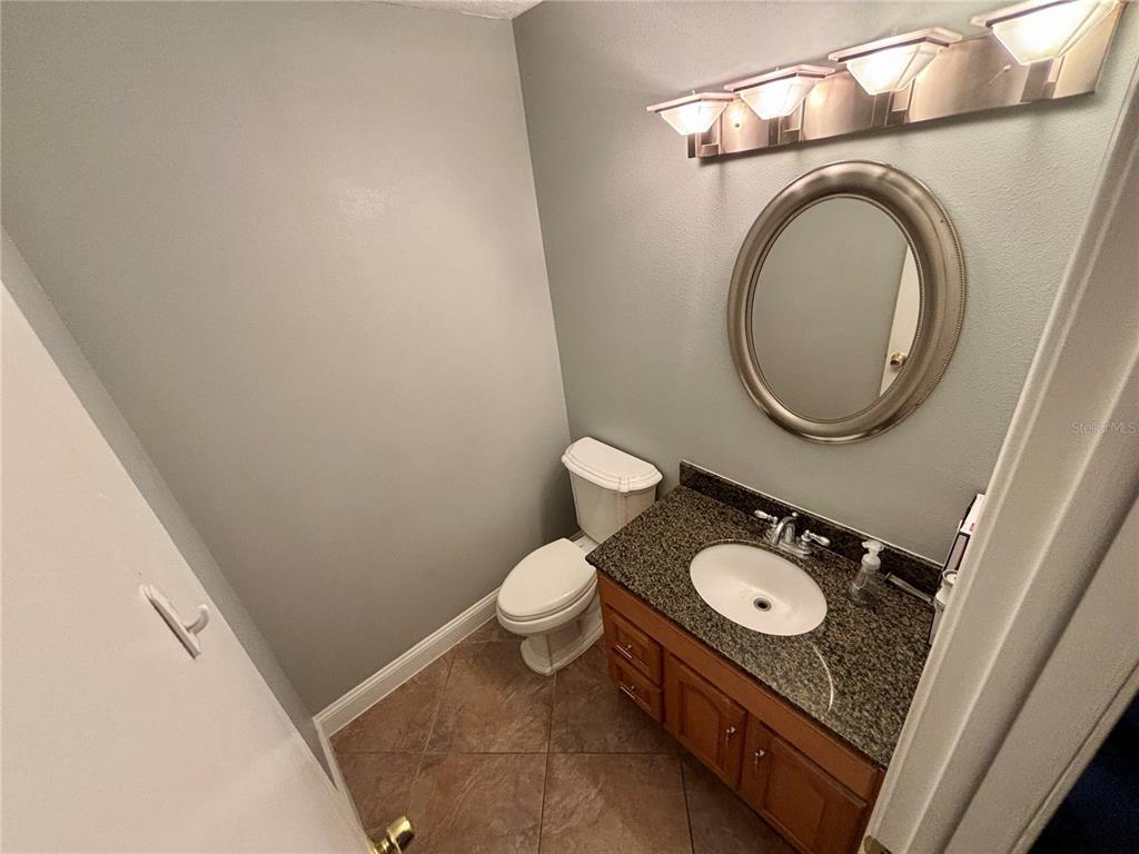 3904 Sweetleaf Drive Brandon, FL 33511 - Photo 23 of 34 a bathroom with a toilet mirror and vanity
