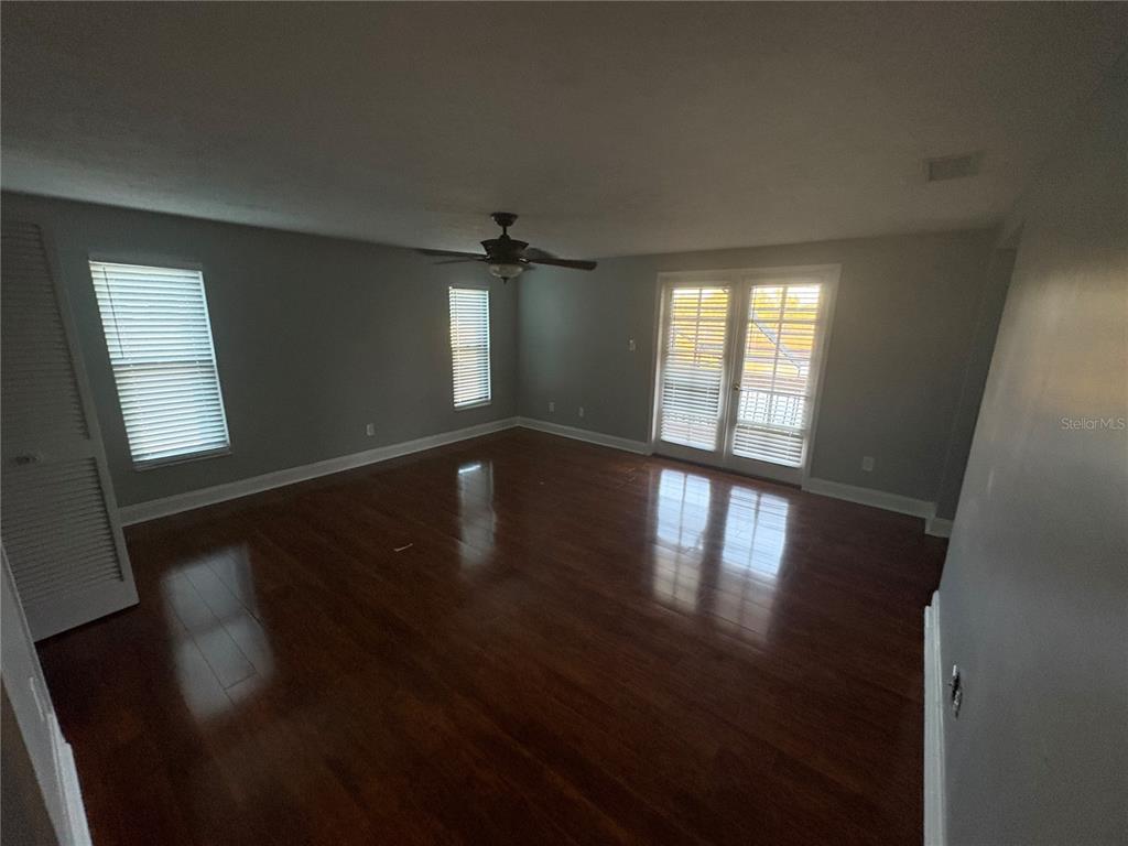 3904 Sweetleaf Drive Brandon, FL 33511 - Photo 25 of 34 an empty room with wooden floor and windows