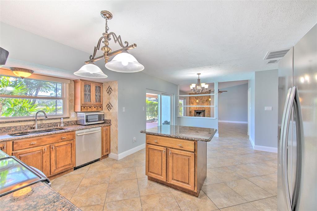 3904 Sweetleaf Drive Brandon, FL 33511 - Photo 27 of 66 a kitchen with stainless steel appliances granite countertop a stove a sink and a refrigerator