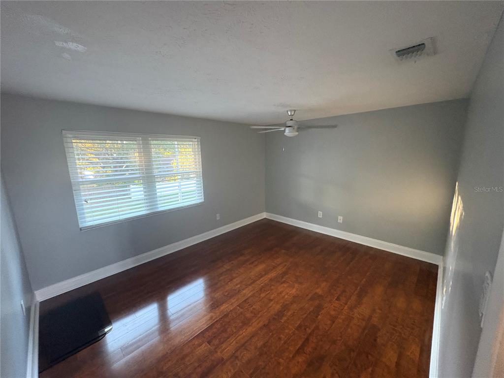 3904 Sweetleaf Drive Brandon, FL 33511 - Photo 32 of 34 an empty room with wooden floor and windows