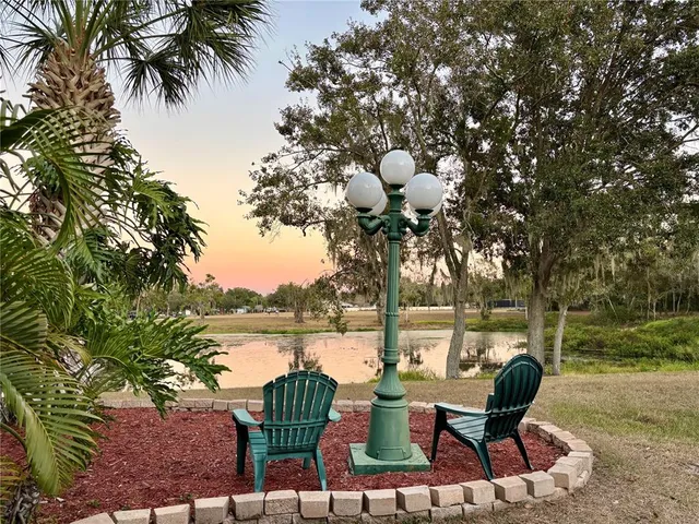 a view of a lake with table and chairs