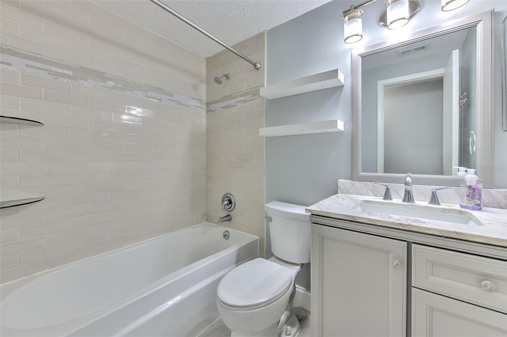 3904 Sweetleaf Drive Brandon, FL 33511 - Photo 42 of 66 a bathroom with a toilet a sink a mirror a bathtub and vanity