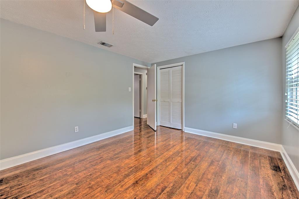 3904 Sweetleaf Drive Brandon, FL 33511 - Photo 45 of 66 a view of an empty room with wooden floor and a window