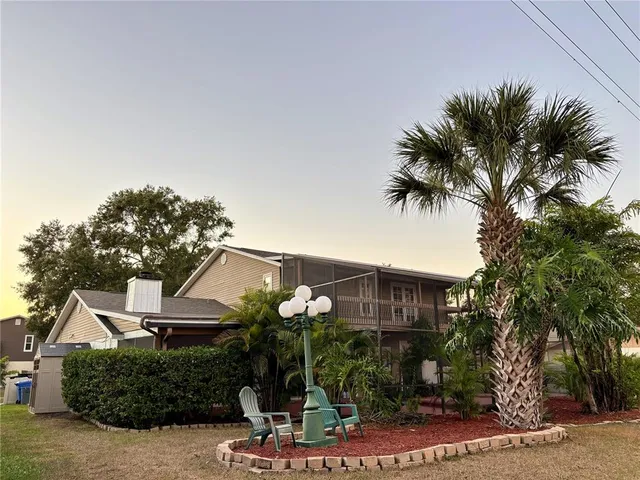 a front view of a house with plants
