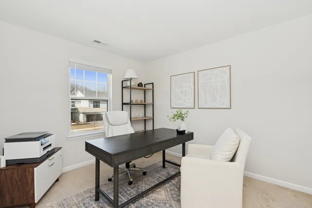 a view of a workspace with furniture