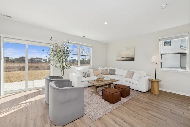 a living room with furniture and a large window
