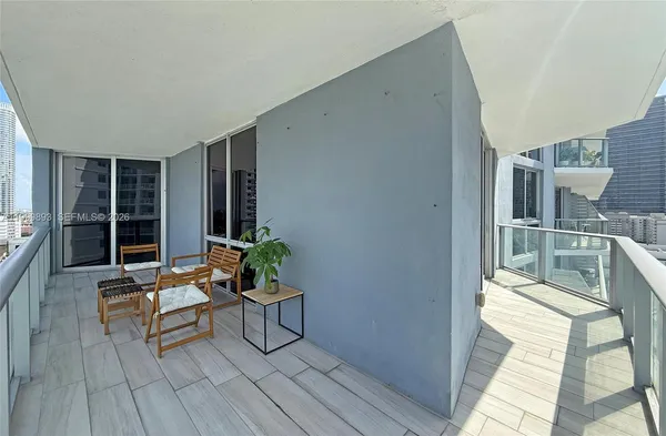 a living room with furniture and large windows