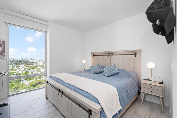a bedroom with a large bed and a window