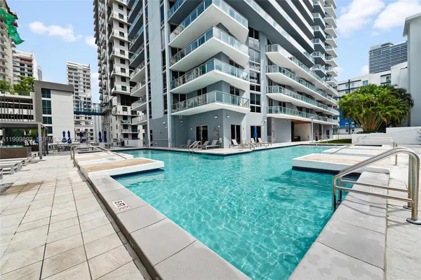 a swimming pool with outdoor seating and yard