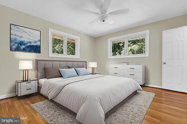 a bedroom with a bed and a painting on the wall