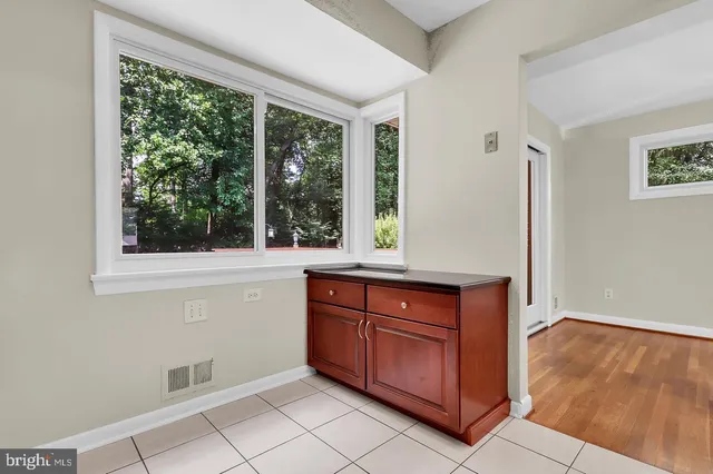 a room with wooden cabinets and a window