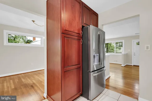 a kitchen with stainless steel appliances granite countertop a refrigerator and a refrigerator