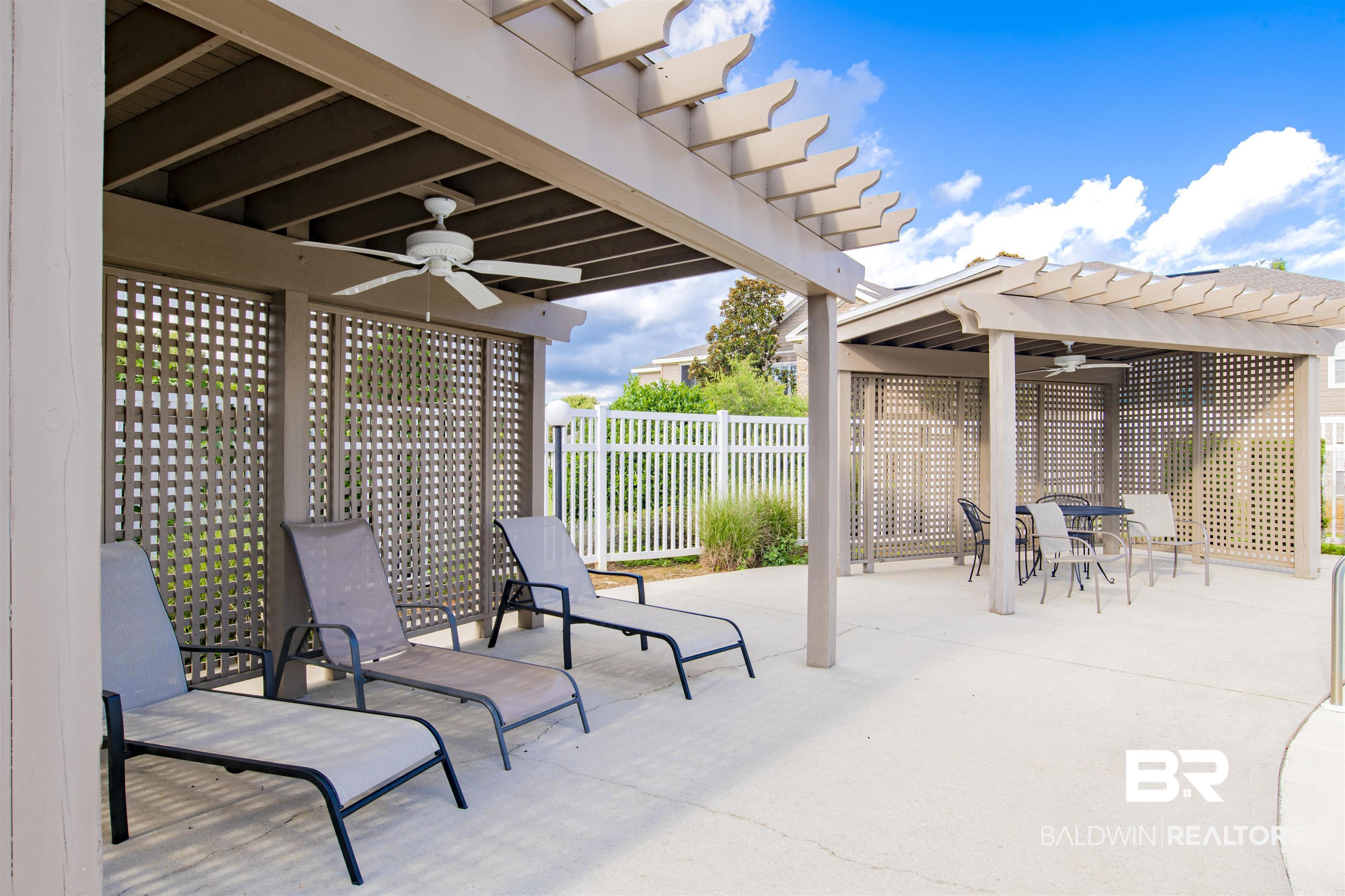 450 Park Avenue, Unit 202 Foley, AL 36535 - Photo 15 of 18 View of patio / terrace featuring ceiling fan, a pergola, and outdoor dining space