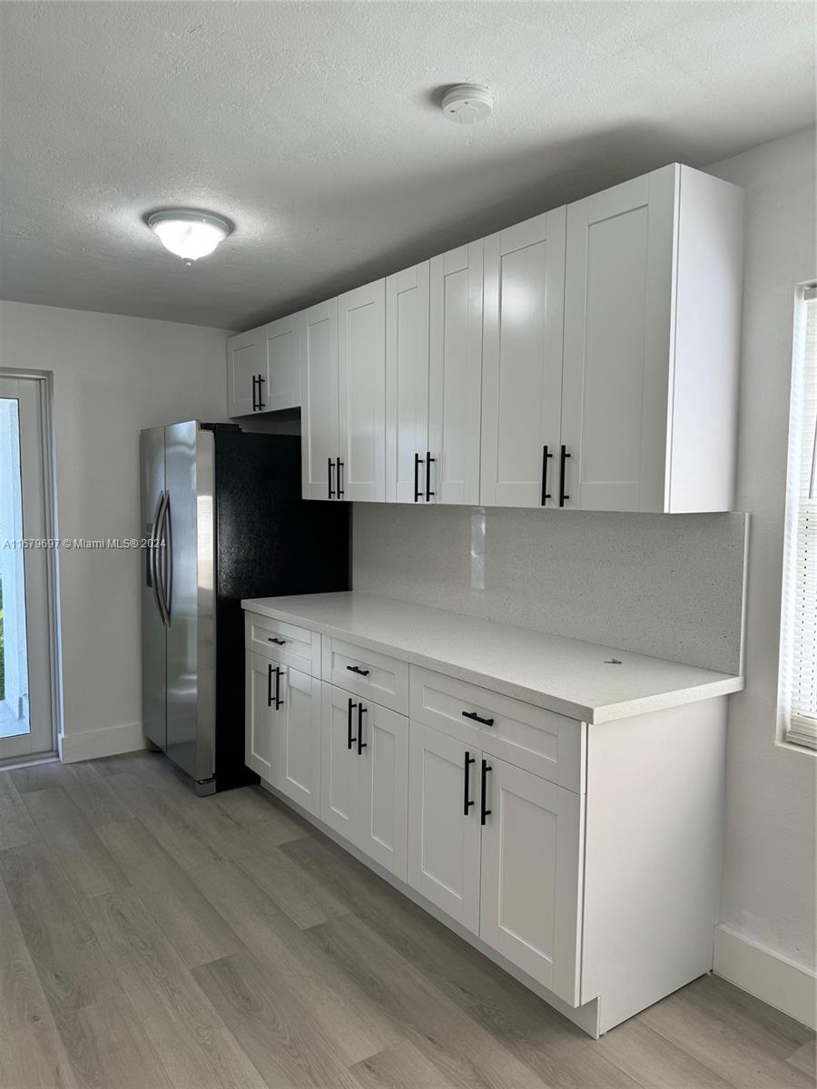 1830 Service Road Opa-Locka, FL 33054 - Photo 8 of 39 a kitchen with a refrigerator sink and cabinets