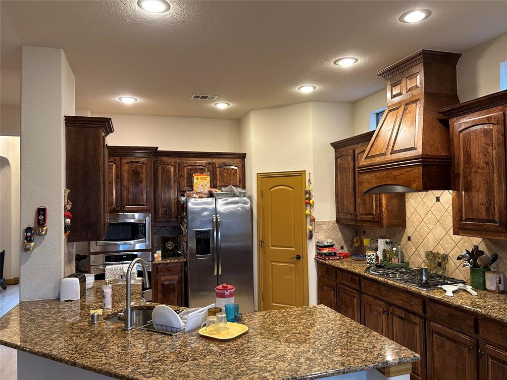 2219 Longview Road Irving, TX 75063 - Photo 14 of 36 a kitchen with refrigerator and sink