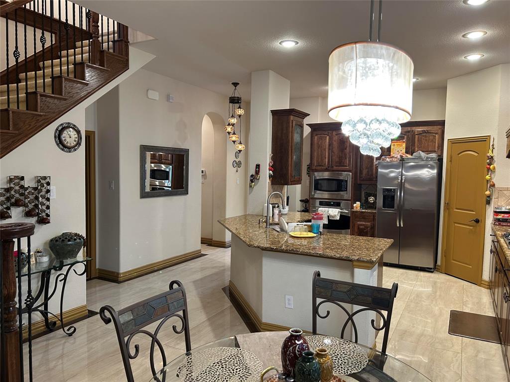 2219 Longview Road Irving, TX 75063 - Photo 19 of 36 a view of a kitchen and dining area with chandelier