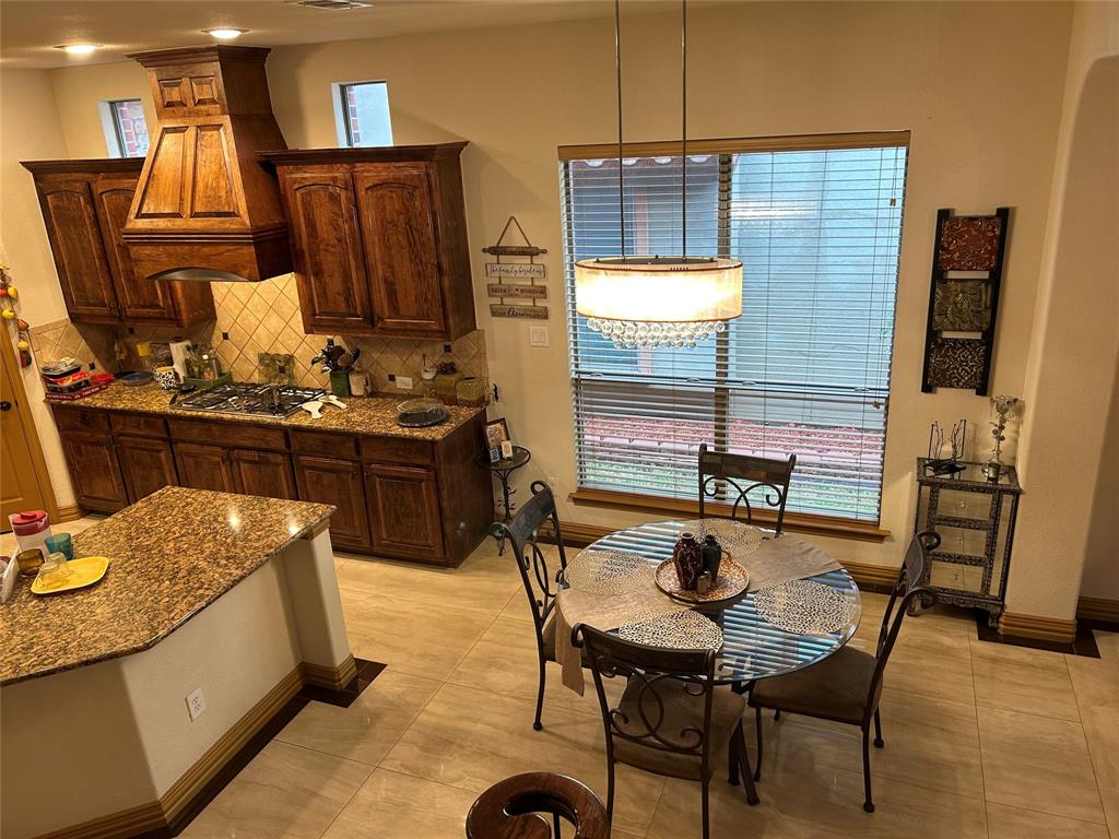 2219 Longview Road Irving, TX 75063 - Photo 22 of 36 a kitchen with a table chairs and a stove