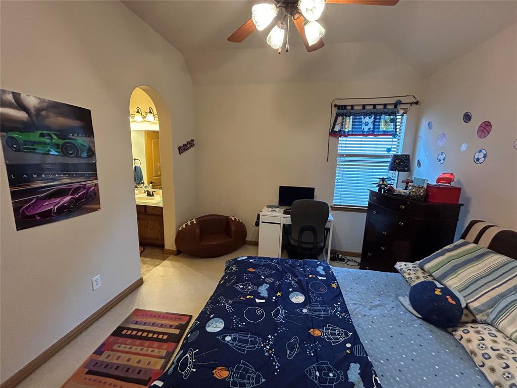 2219 Longview Road Irving, TX 75063 - Photo 26 of 36 a bedroom with a bed and a chandelier