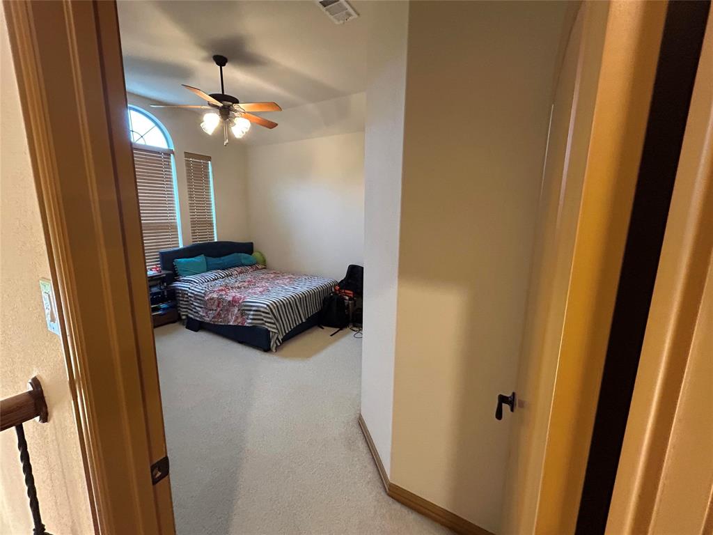 2219 Longview Road Irving, TX 75063 - Photo 28 of 36 a bedroom with a bed and a chandelier