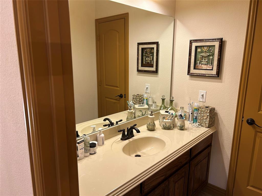 2219 Longview Road Irving, TX 75063 - Photo 30 of 36 a bathroom with a sink and a mirror