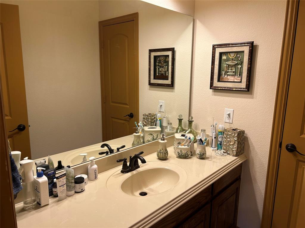 2219 Longview Road Irving, TX 75063 - Photo 32 of 36 a bathroom with a sink and a mirror