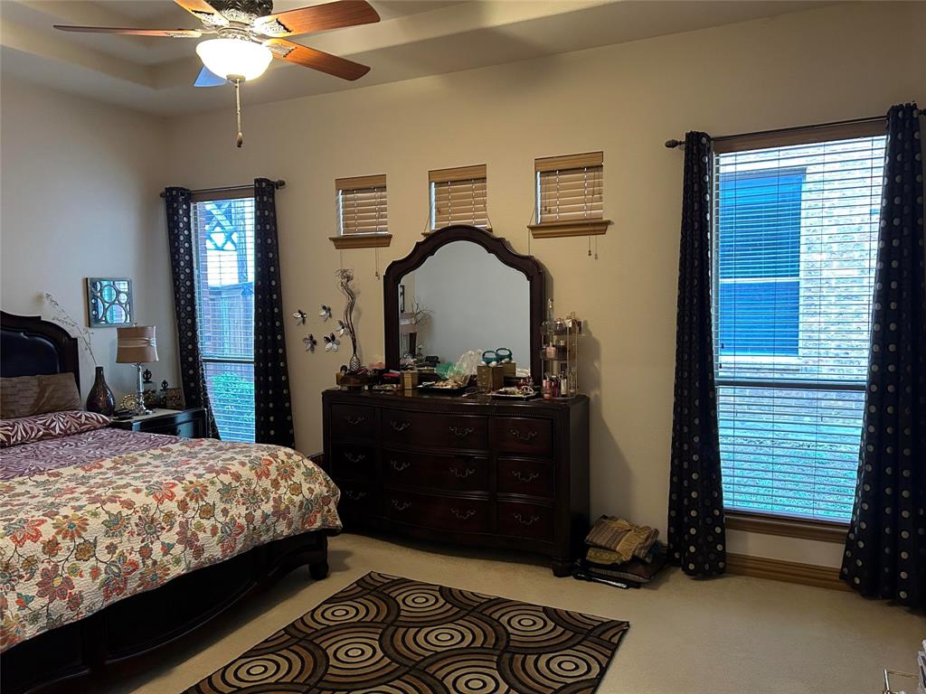 2219 Longview Road Irving, TX 75063 - Photo 33 of 36 a bedroom with a bed and a chandelier