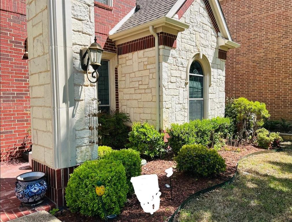 2219 Longview Road Irving, TX 75063 - Photo 6 of 36 a view of a house with a yard and potted plants
