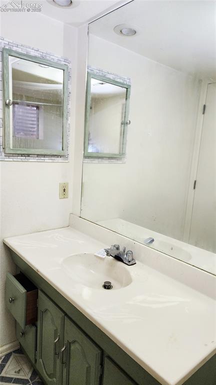 290 Cobblestone Drive Colorado Springs, CO 80906 - Photo 18 of 30 a bathroom with a sink and a mirror