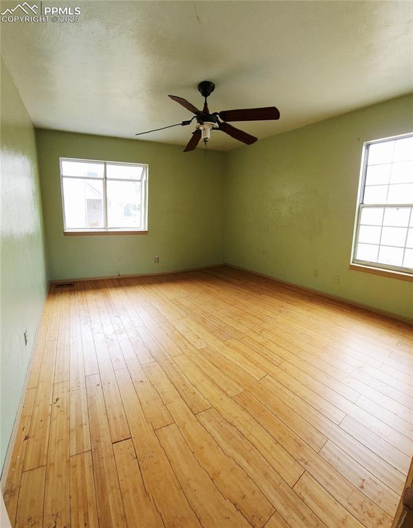 290 Cobblestone Drive Colorado Springs, CO 80906 - Photo 10 of 30 wooden floor in an empty room with a window