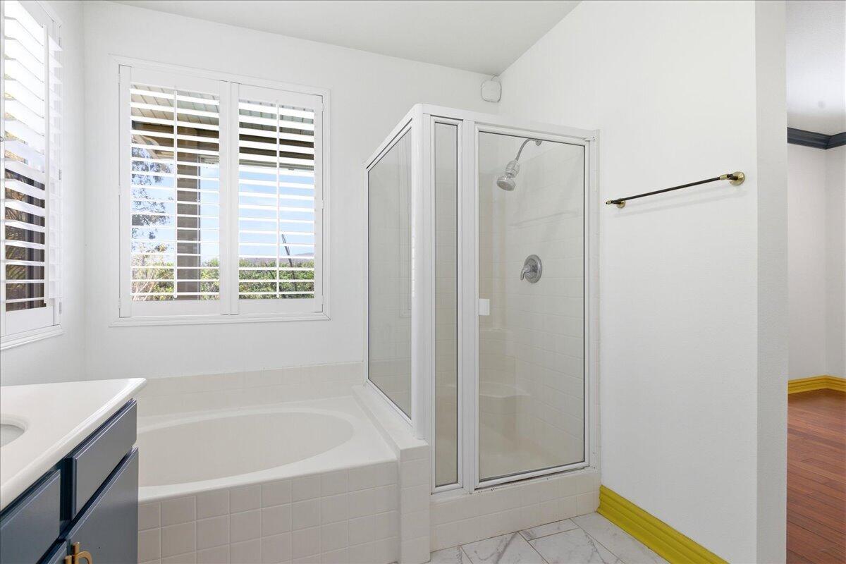 23732 Bella Vista Road Corona, CA 92883 - Photo 23 of 49 a bathroom with a bathtub and a shower