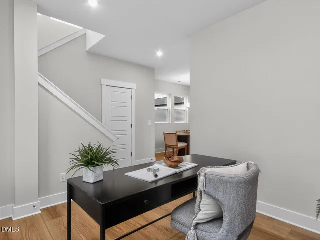 a view of a room with furniture and wooden floor