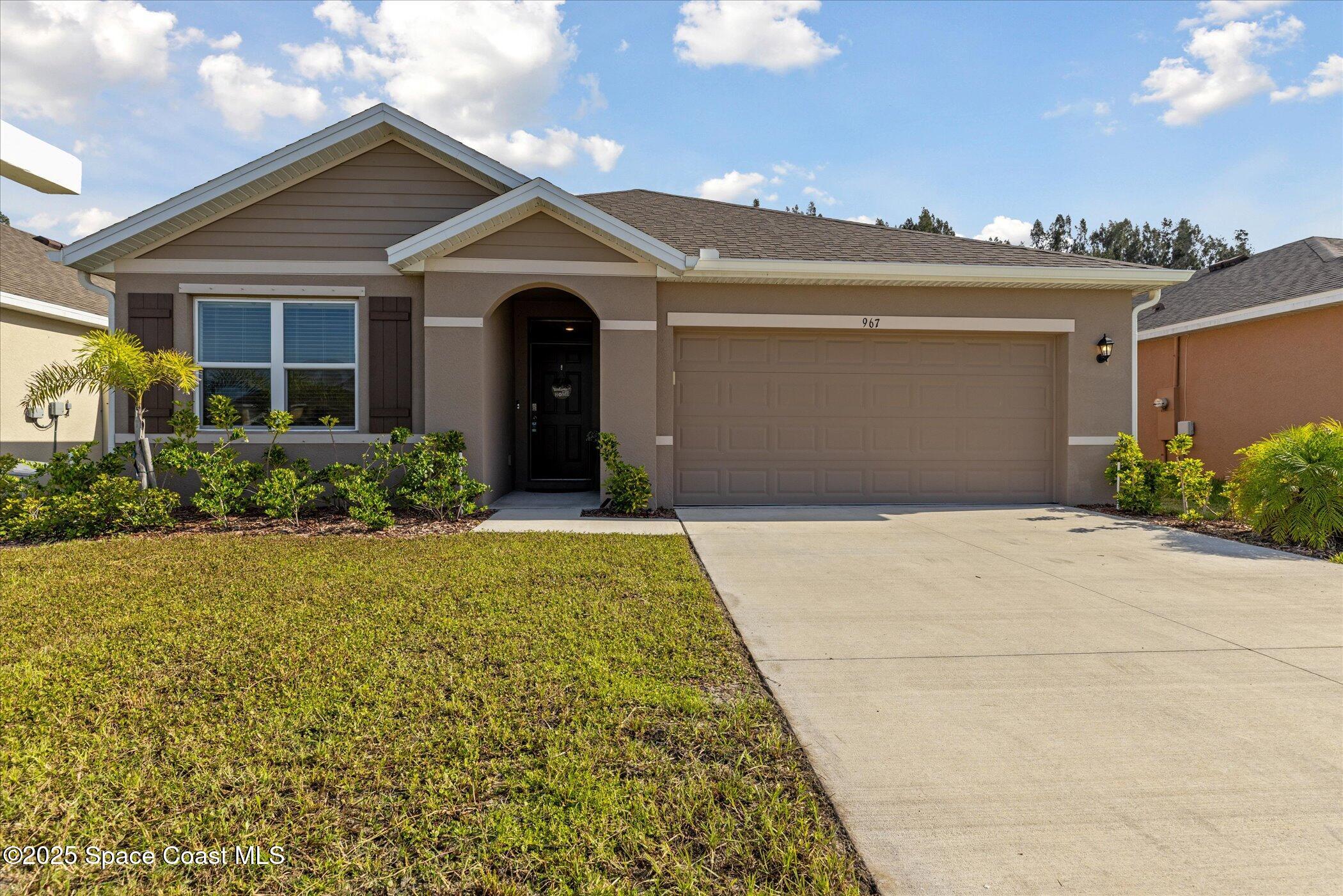 967 Trinity Street Rockledge, FL 32955 - Photo 1 of 40 front view of a house with a yard