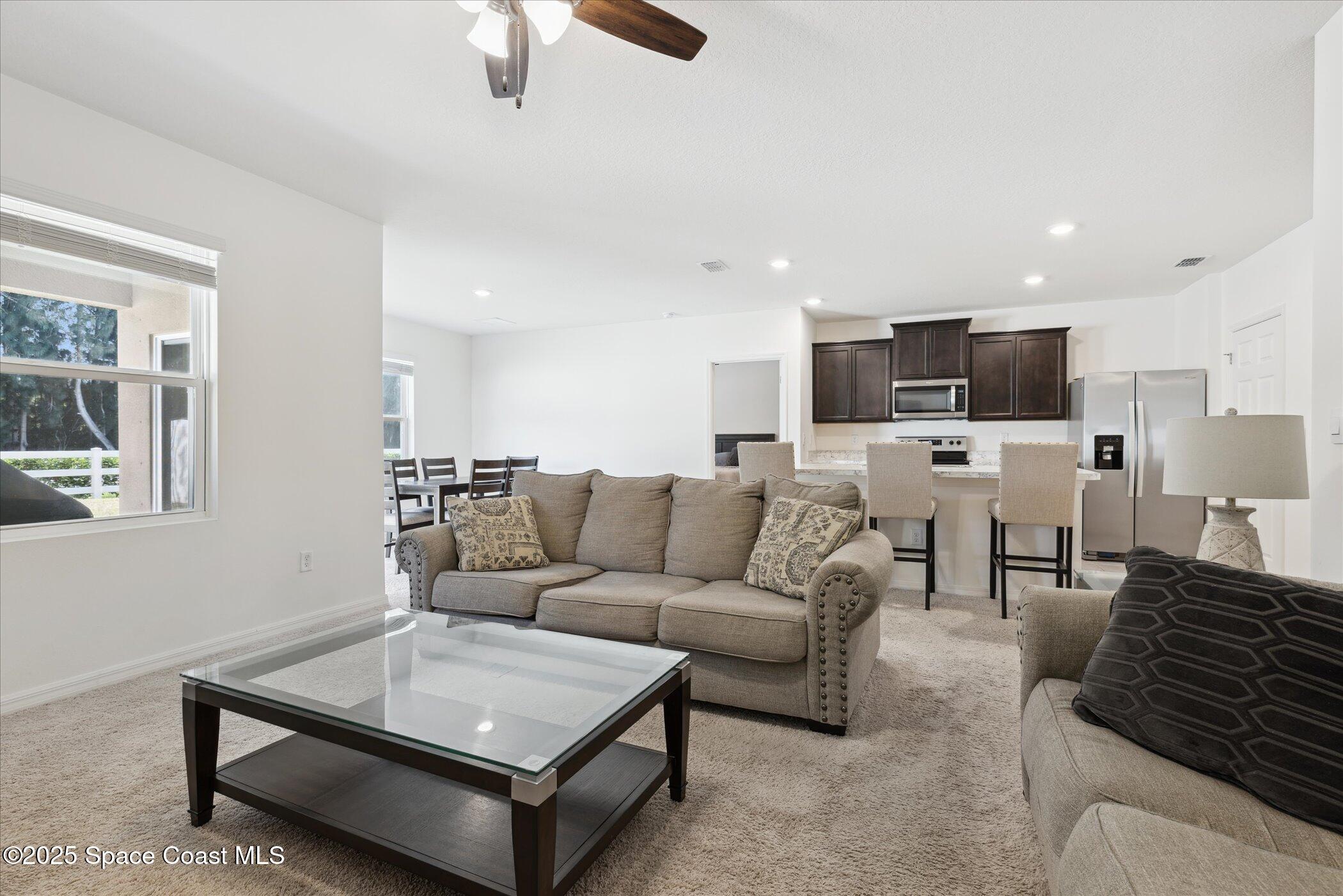 967 Trinity Street Rockledge, FL 32955 - Photo 11 of 40 a living room with furniture and a view of kitchen