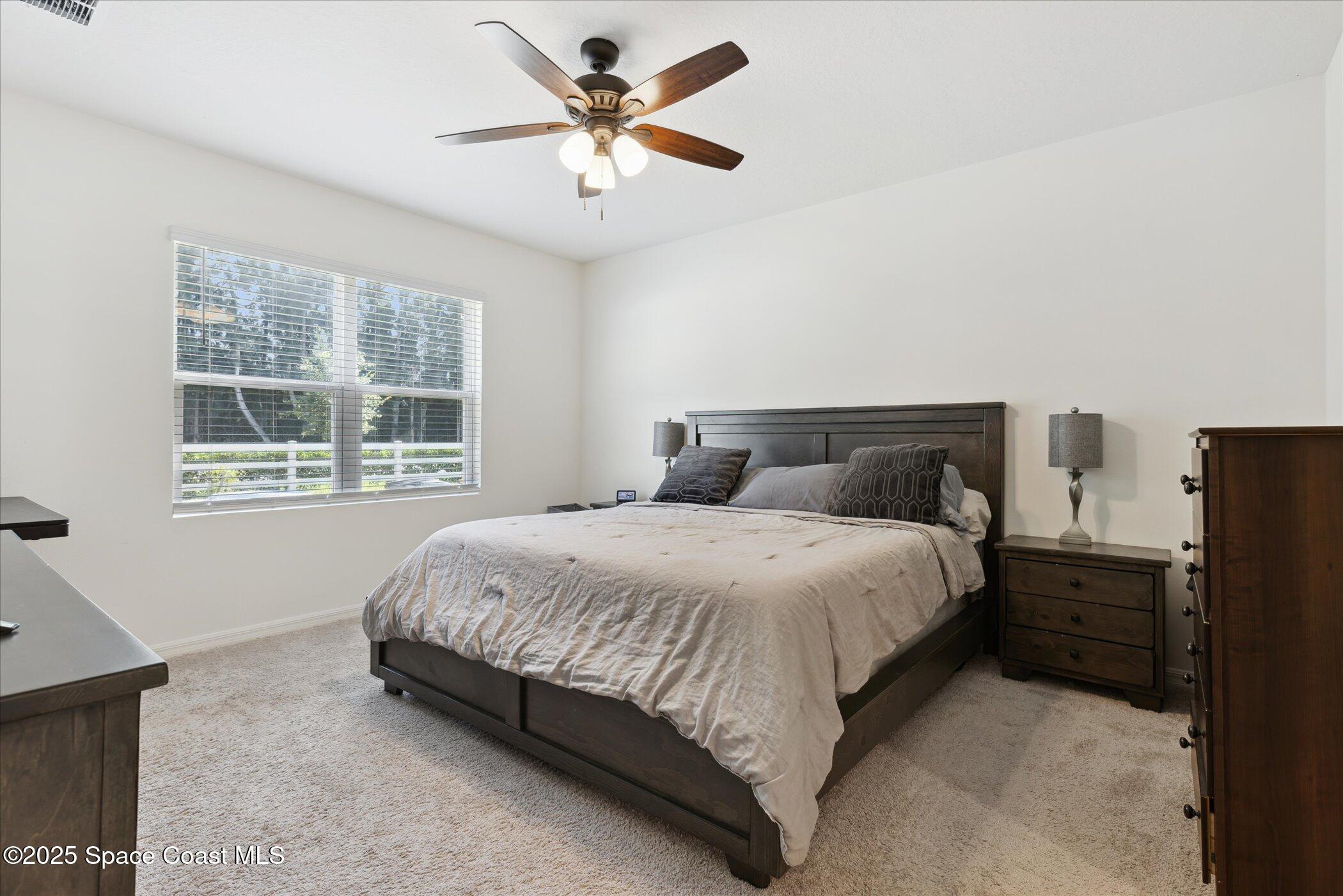 967 Trinity Street Rockledge, FL 32955 - Photo 17 of 40 a bedroom with a bed and a window
