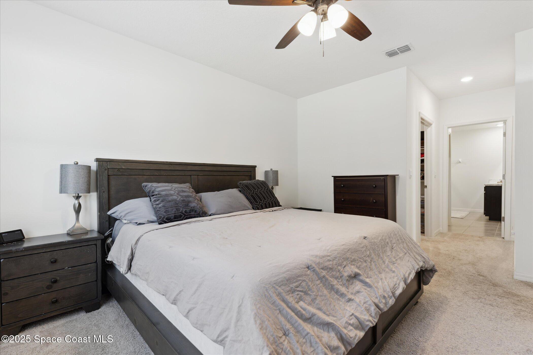 967 Trinity Street Rockledge, FL 32955 - Photo 19 of 40 a bedroom with a bed and ceiling fan