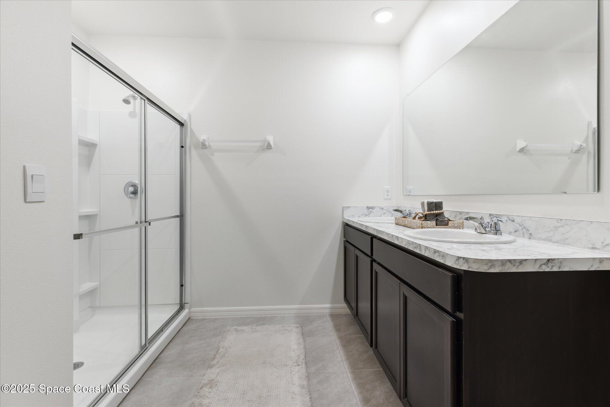 967 Trinity Street Rockledge, FL 32955 - Photo 22 of 40 a bathroom with a sink and a mirror