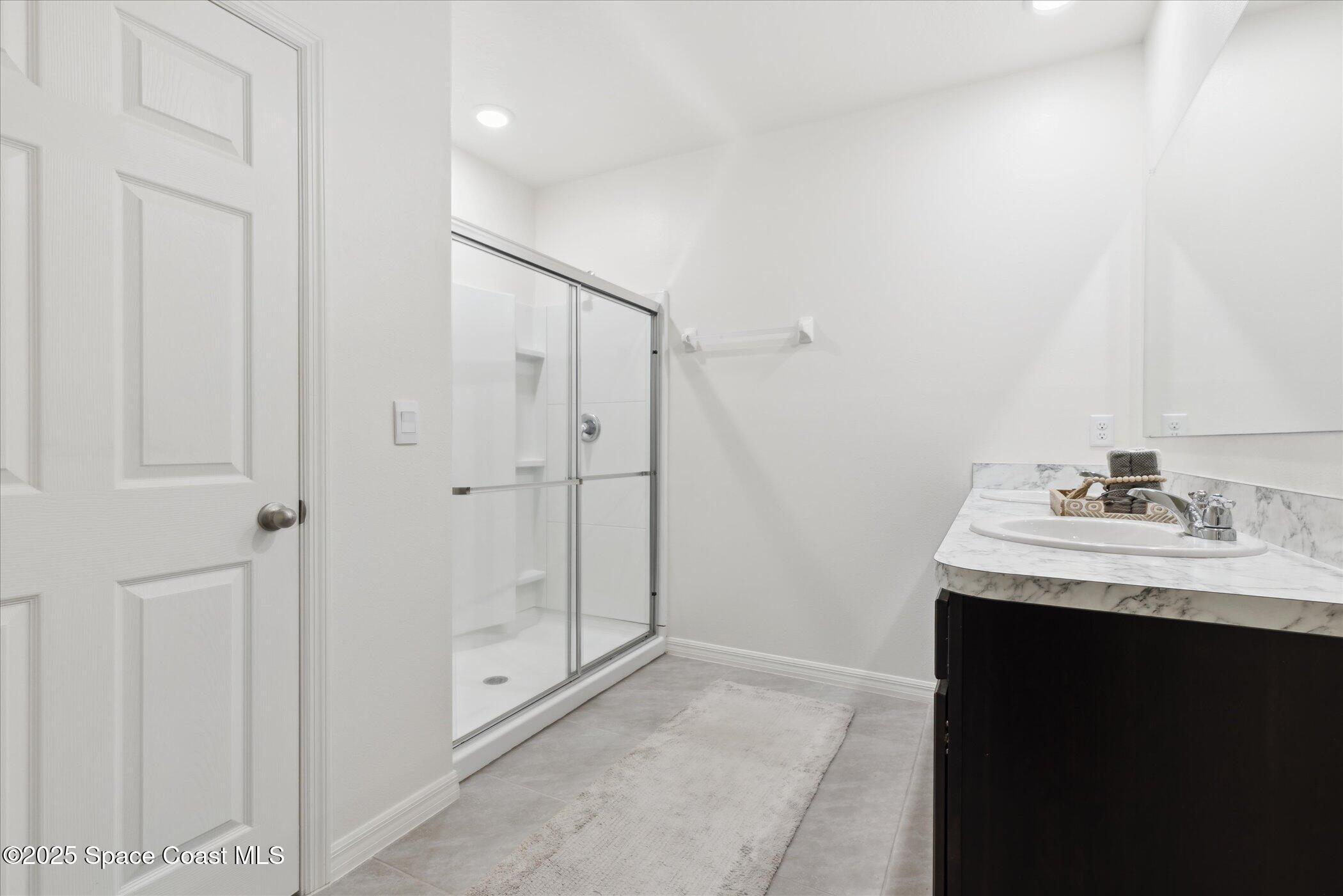967 Trinity Street Rockledge, FL 32955 - Photo 23 of 40 a bathroom with a granite countertop sink and a mirror
