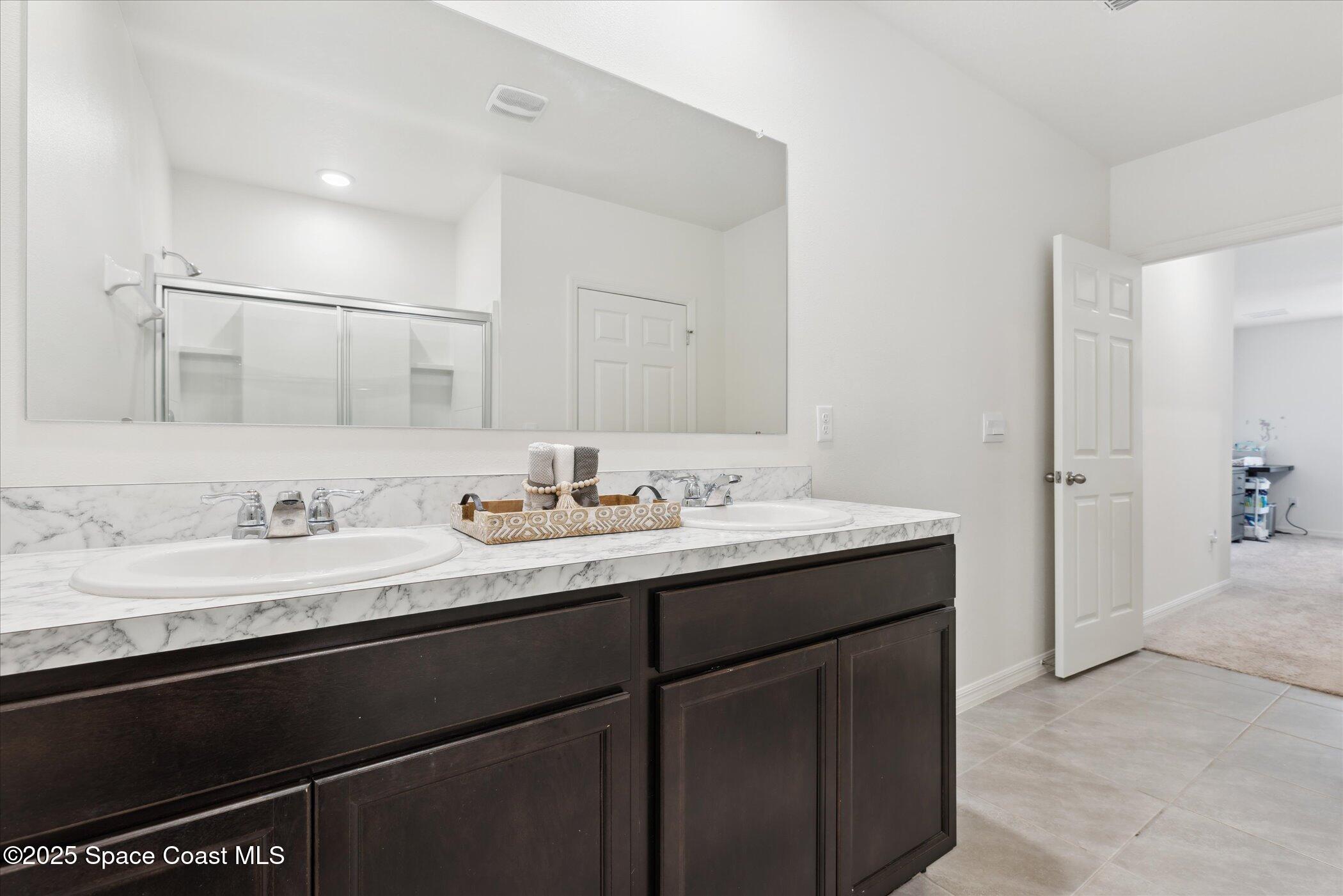 967 Trinity Street Rockledge, FL 32955 - Photo 25 of 40 a bathroom with a sink and a mirror