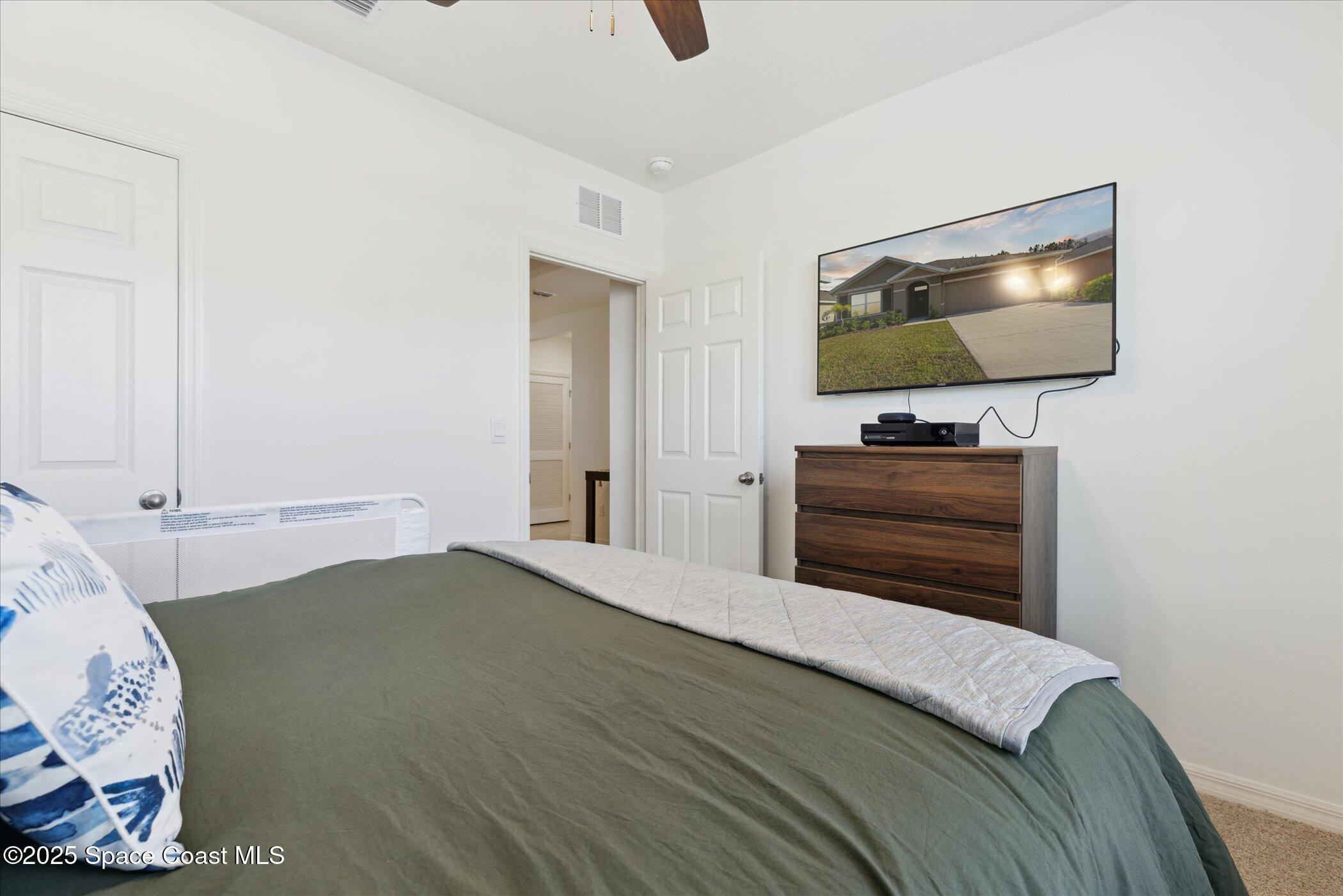 967 Trinity Street Rockledge, FL 32955 - Photo 30 of 40 a living room with furniture and a flat screen tv