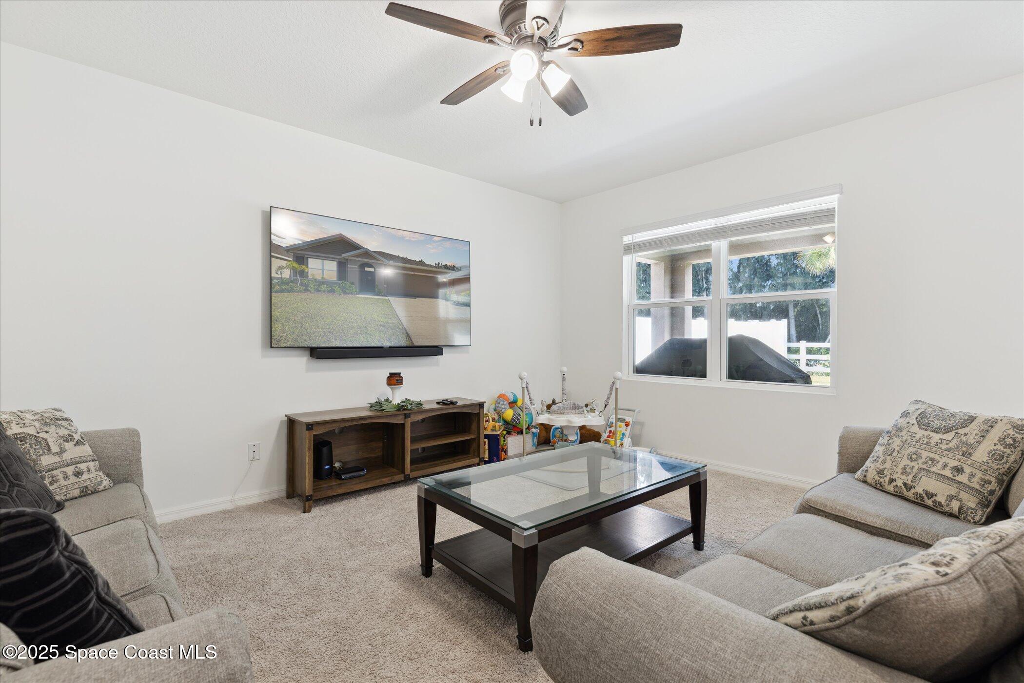 967 Trinity Street Rockledge, FL 32955 - Photo 3 of 40 a living room with furniture and a flat screen tv