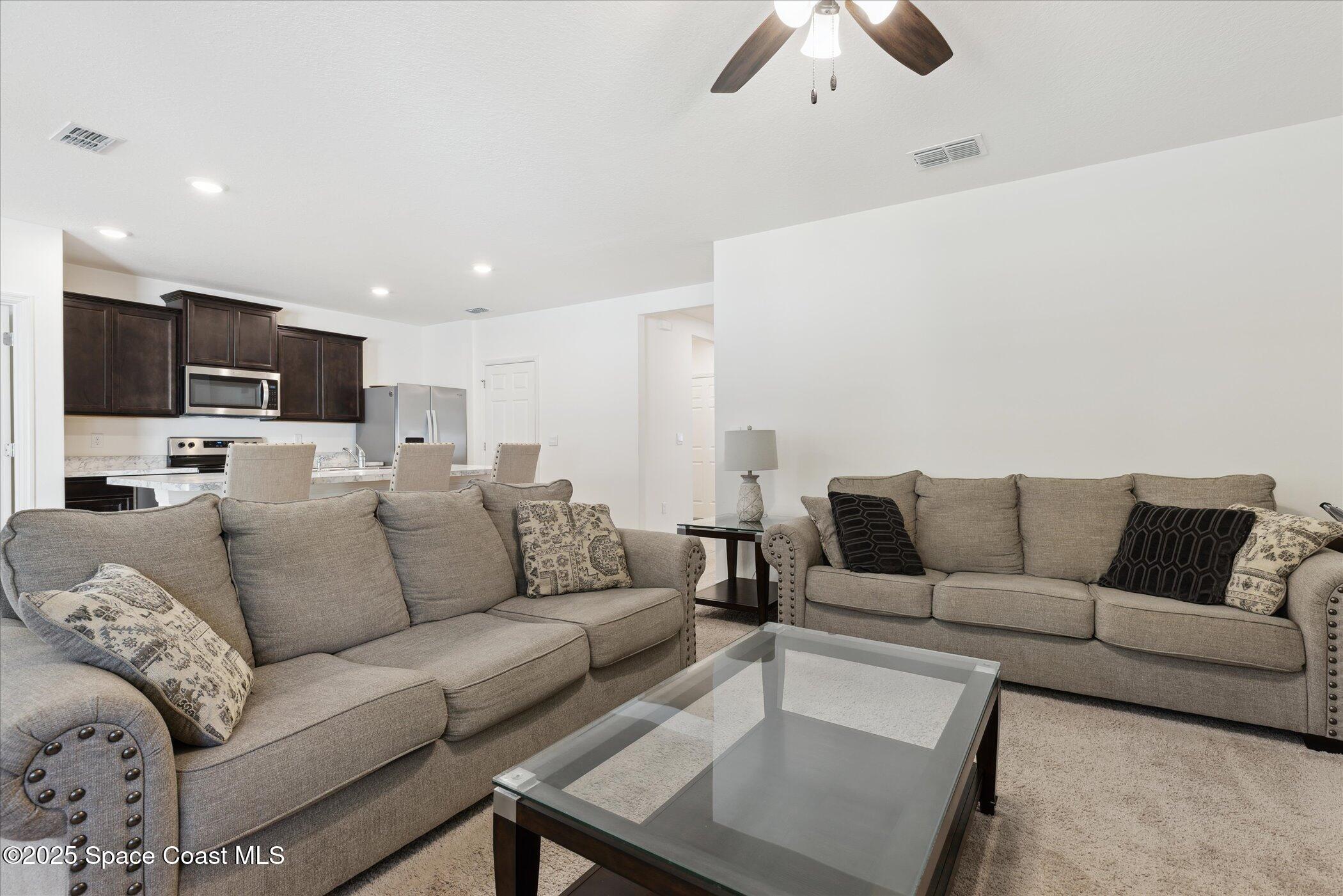967 Trinity Street Rockledge, FL 32955 - Photo 10 of 40 a living room with furniture and a flat screen tv