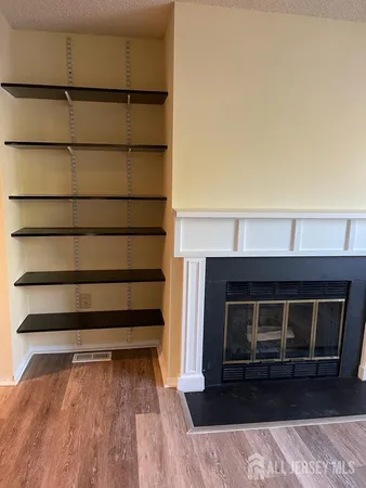 a living room with a furniture and a fireplace