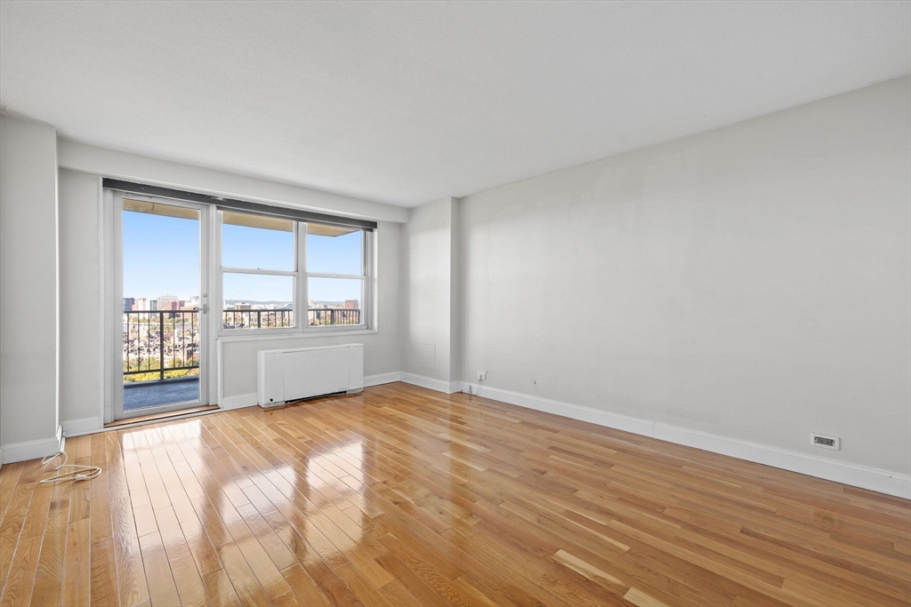 151 Tremont Street, Unit 24P Boston, MA 02111 - Photo 15 of 38 a view of a kitchen with wooden floor and cabinet