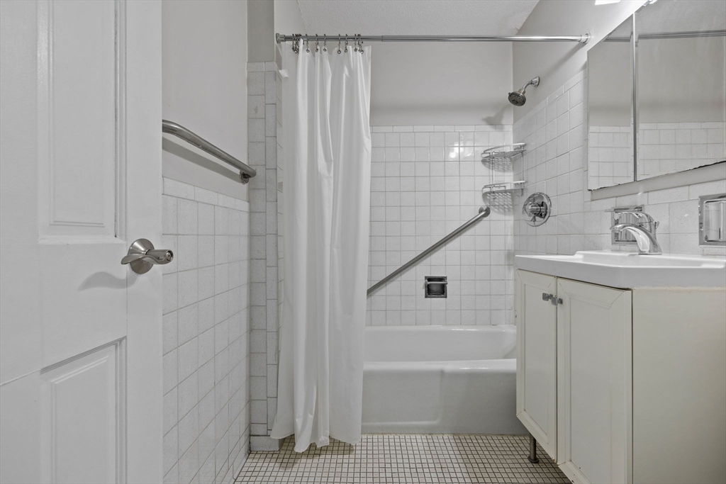 151 Tremont Street, Unit 24P Boston, MA 02111 - Photo 22 of 38 a bathroom with a sink a toilet and shower