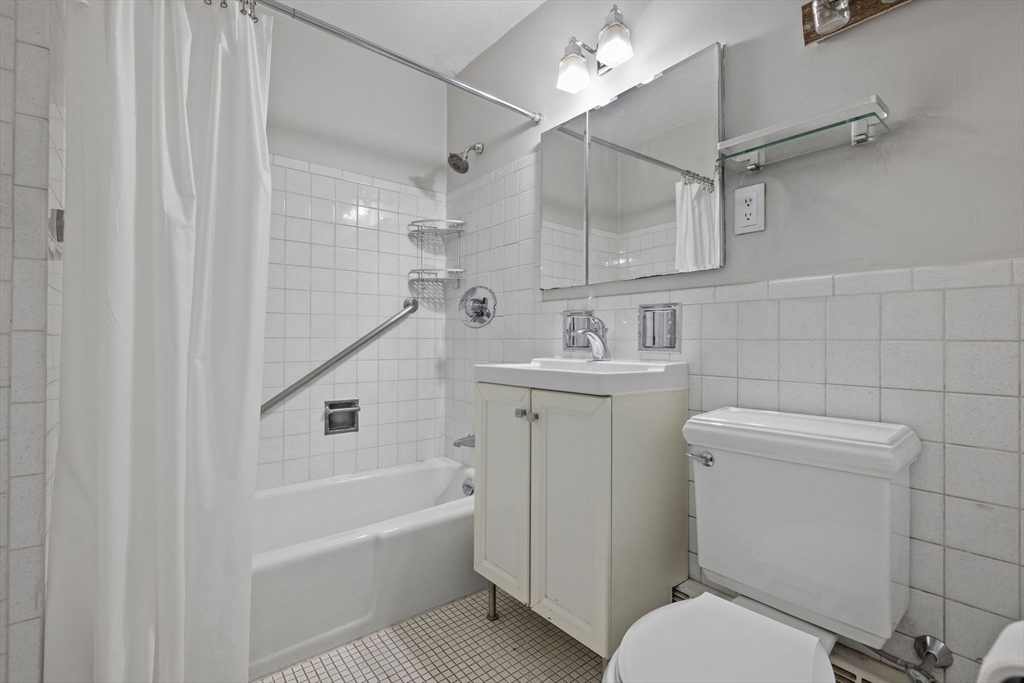 151 Tremont Street, Unit 24P Boston, MA 02111 - Photo 23 of 38 a bathroom with a sink a toilet and shower