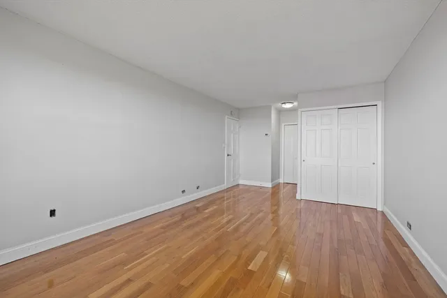 a view of an empty room and wooden floor