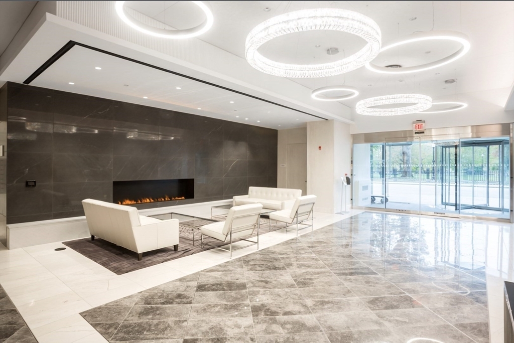 151 Tremont Street, Unit 24P Boston, MA 02111 - Photo 33 of 38 a living room with a large window and white furniture