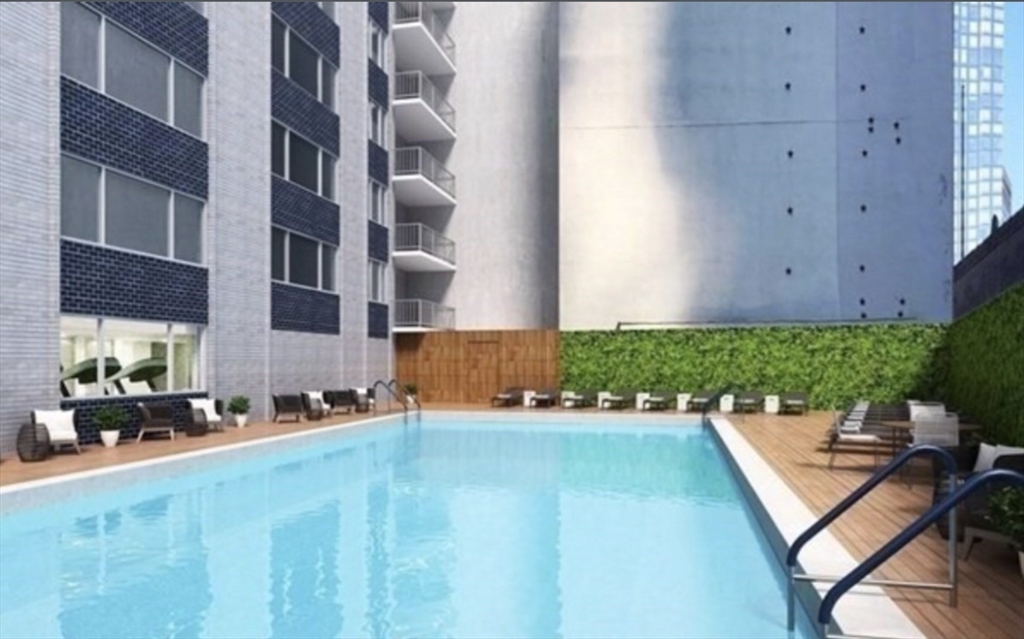 151 Tremont Street, Unit 24P Boston, MA 02111 - Photo 34 of 38 a front view of a house with a yard